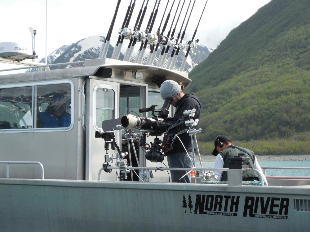 Filming the Yakutat seal hunt: Nicholas Bradford and Brandon McElroy setting up gyro-mounted video cameras on the ASC's chartered chase boat. Photo credit: Aron Crowell.